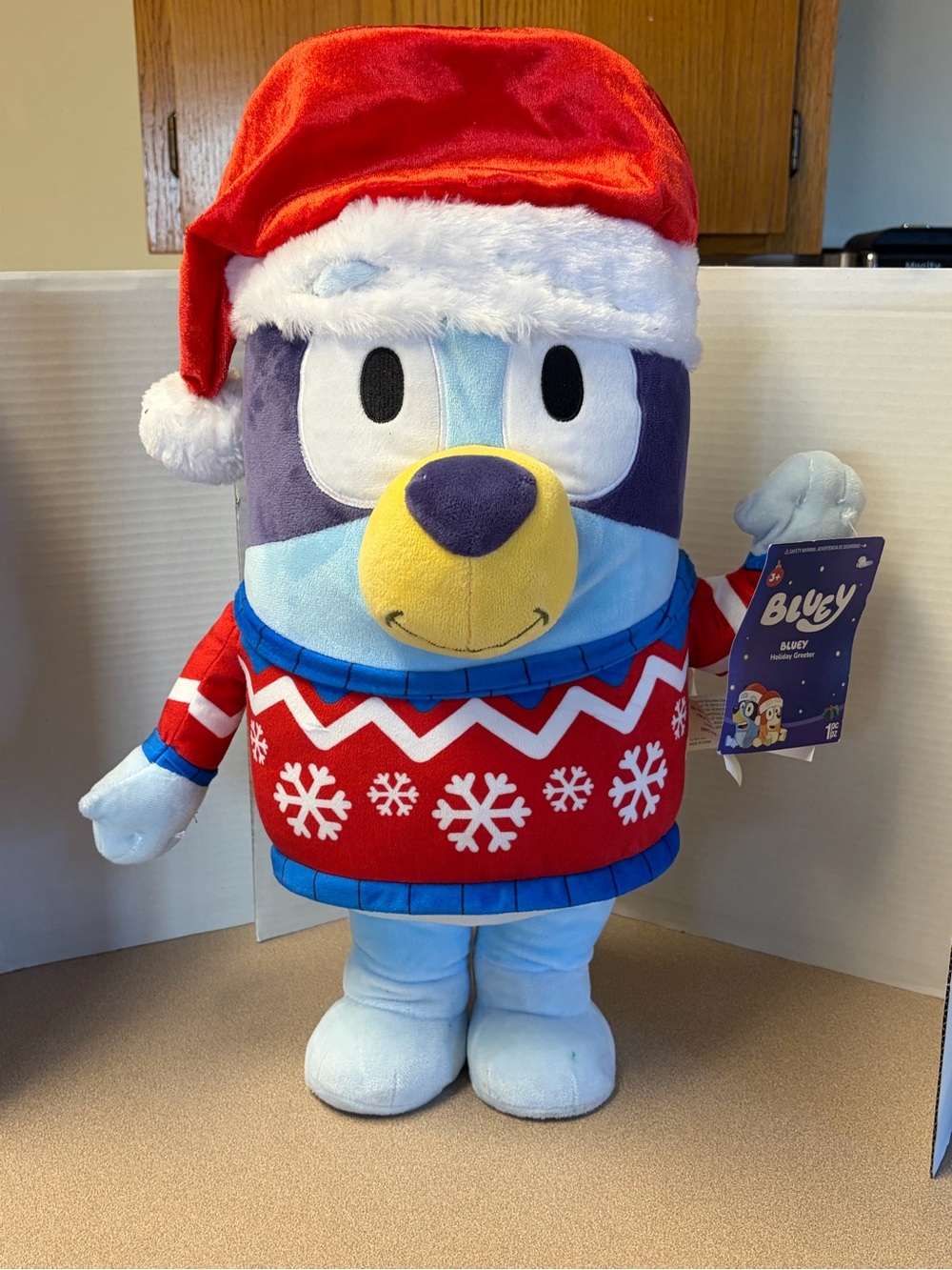 Gemmy Bluey Holiday Greeter wearing a festive red snowflake sweater 2ft